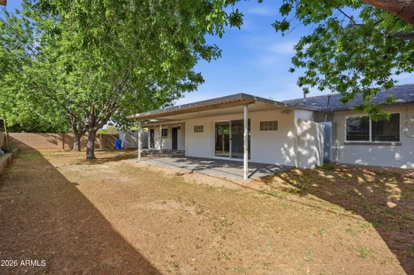 a view of a house with a tree covered by side of the road