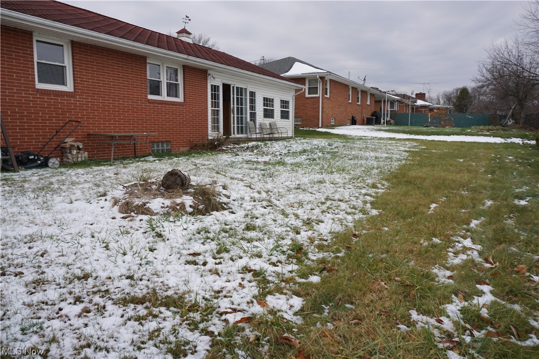 4611 8th Street Northwest Canton, OH 44708 - Photo 23 of 29 Snow covered house with central air condition unit and a yard