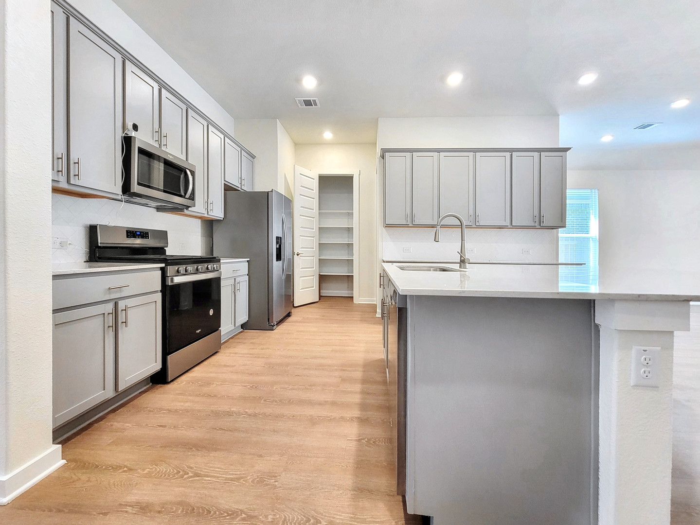 2329 Gabriels Horn Road Leander, TX 78641 - Photo 3 of 23 Culinary dreams come to life in this kitchen, complete with an island and generous counter space.