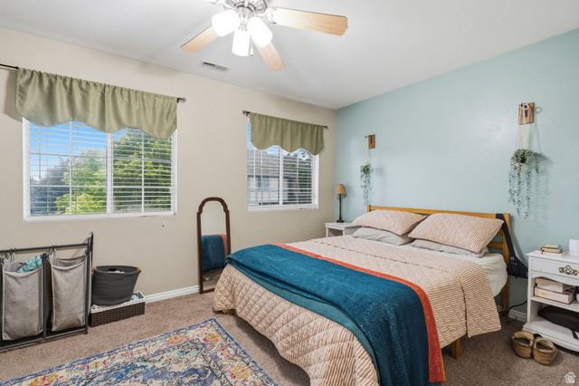 1099 South 950 East, Unit 17 Provo, UT 84606 - Photo 10 of 23 Bedroom featuring two windows with blinds, a ceiling fan, and carpet flooring