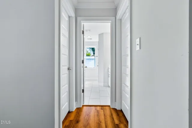 a bathroom with a double vanity sink mirror and next to a window