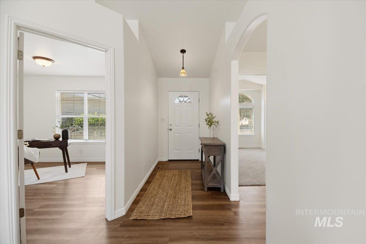 2032 Talus Loop Twin Falls, ID 83301 - Photo 6 of 43 Entryway featuring wood-finish flooring, a white paneled front door with decorative glass, and a pendant light fixture