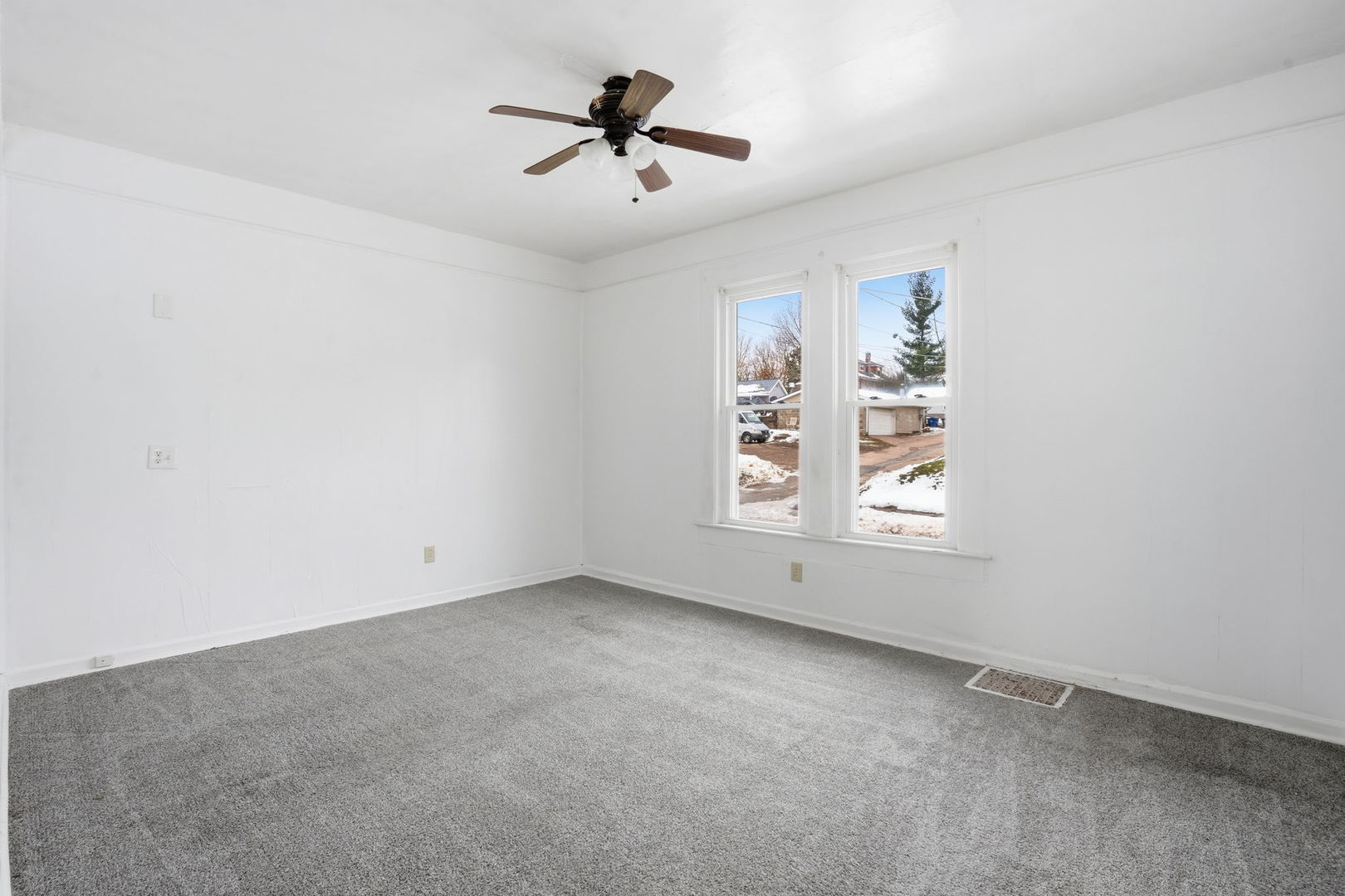 1306 17th Street Moline, IL 61265 - Photo 7 of 14 an empty room with windows and ceiling fan