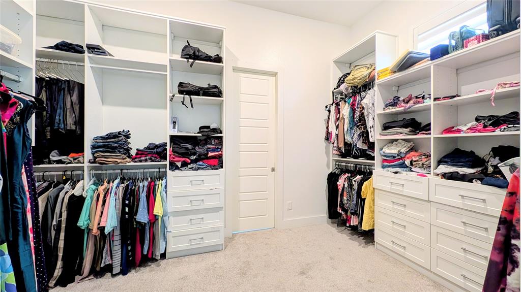 8933 Frostweed Road Frisco, TX 75035 - Photo 18 of 36 a view of walk in closet with clothes and shoes