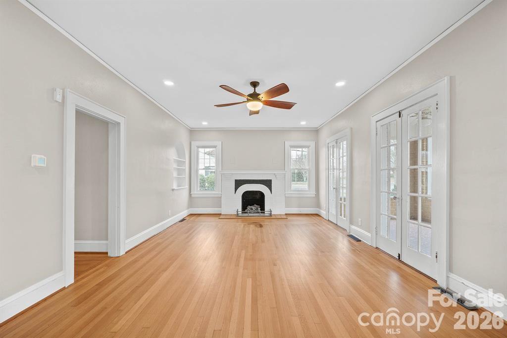 333 7th Street Northwest Hickory, NC 28601 - Photo 6 of 23 a view of a livingroom with a fireplace a ceiling fan and wooden floor