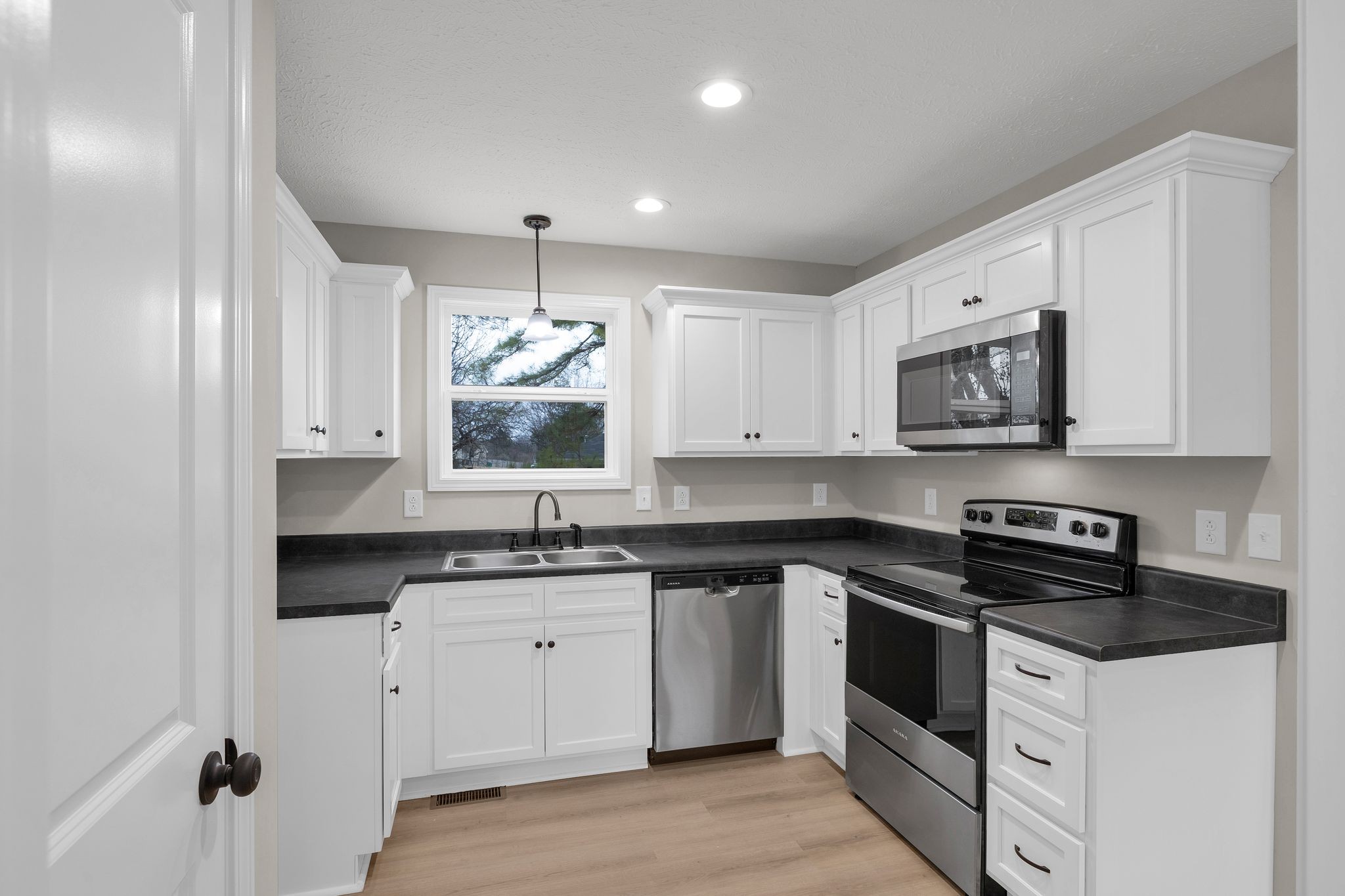 1536 Old Columbia Road Lewisburg, TN 37091 - Photo 7 of 22 a kitchen with a sink stove and white cabinets