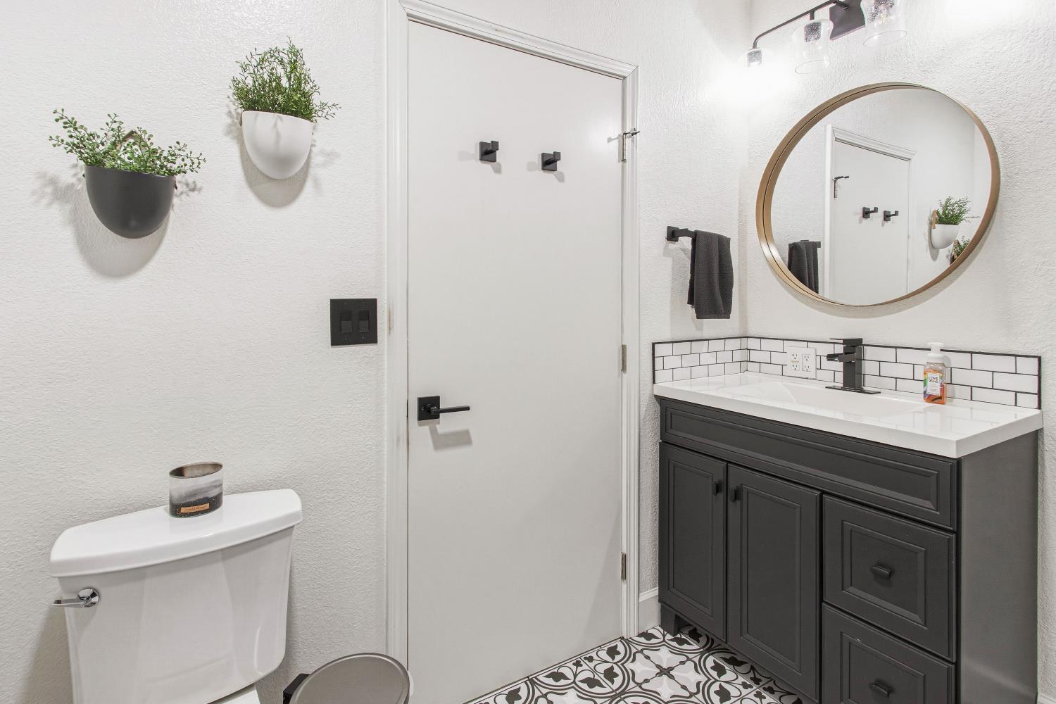 1908 Chelwood Way Modesto, CA 95355 - Photo 14 of 32 a bathroom with a sink a toilet and a mirror