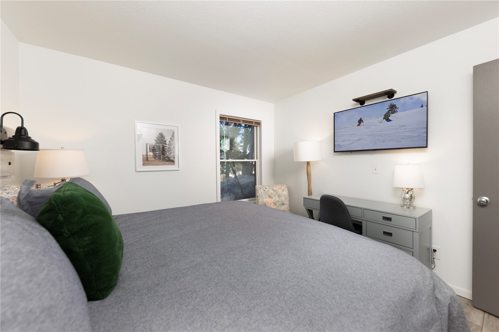 89410 Ryan Gulch Road, Unit 104 Silverthorne, CO 80498 - Photo 28 of 31 a bedroom with a bed and a painting on the wall