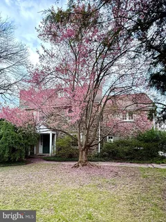a front view of a house with a yard and a garden
