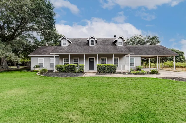 a front view of a house with swimming pool having outdoor seating