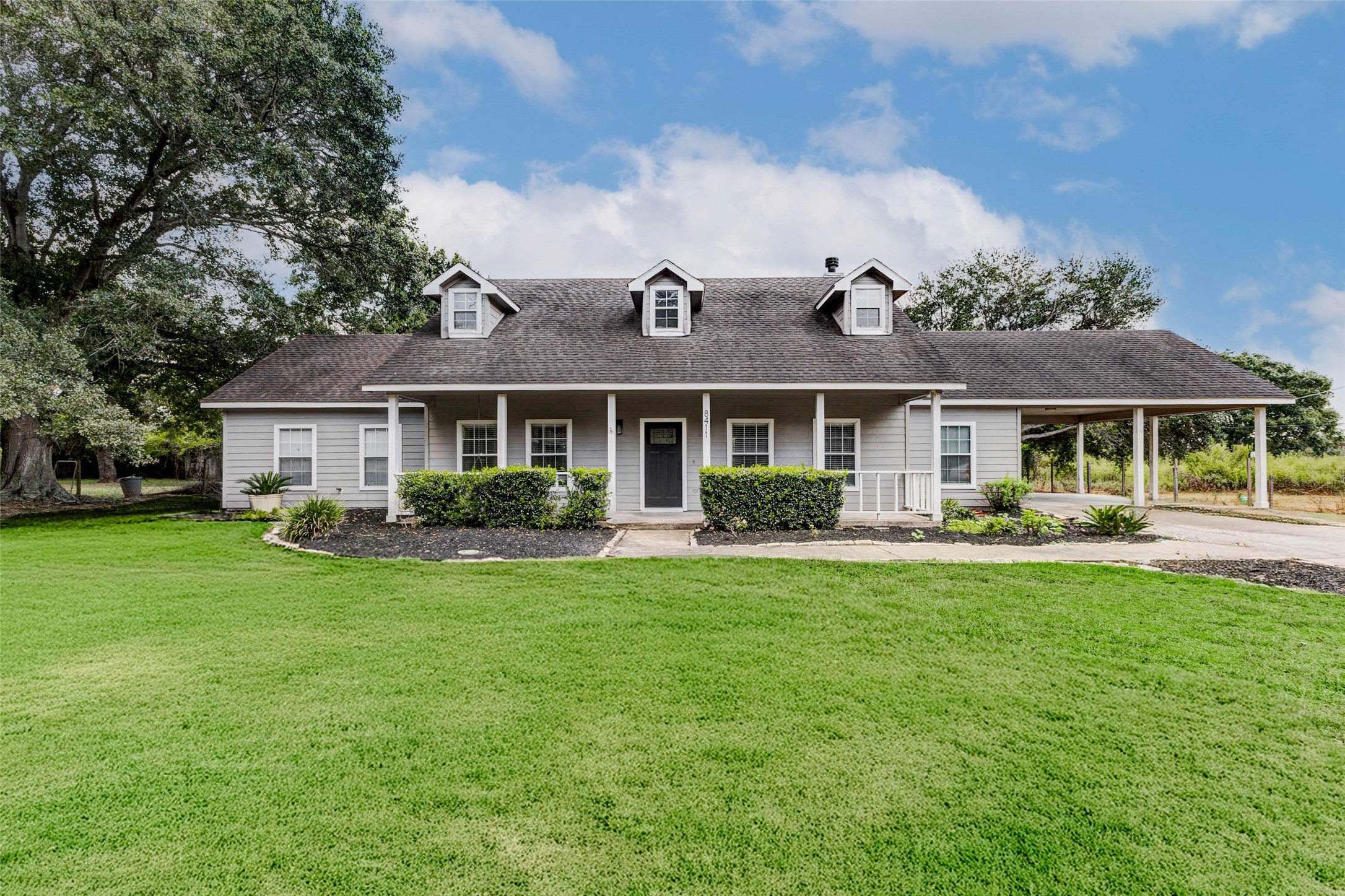 a front view of a house with swimming pool having outdoor seating