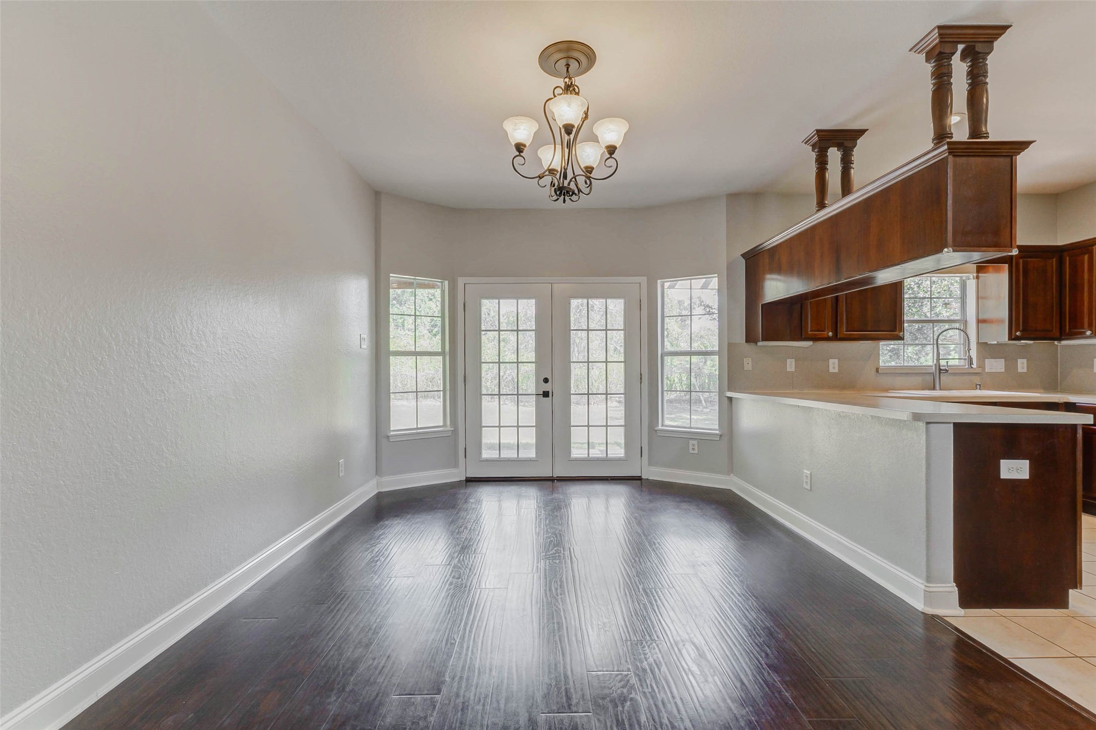 8411 Syms Street Fulshear, TX 77441 - Photo 11 of 29 a view of an empty room with a window and wooden floor