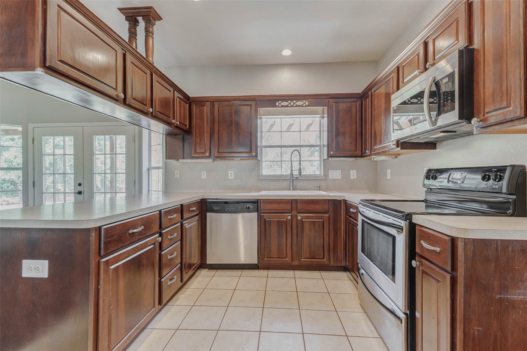 8411 Syms Street Fulshear, TX 77441 - Photo 12 of 29 a kitchen with stainless steel appliances granite countertop a sink and cabinets