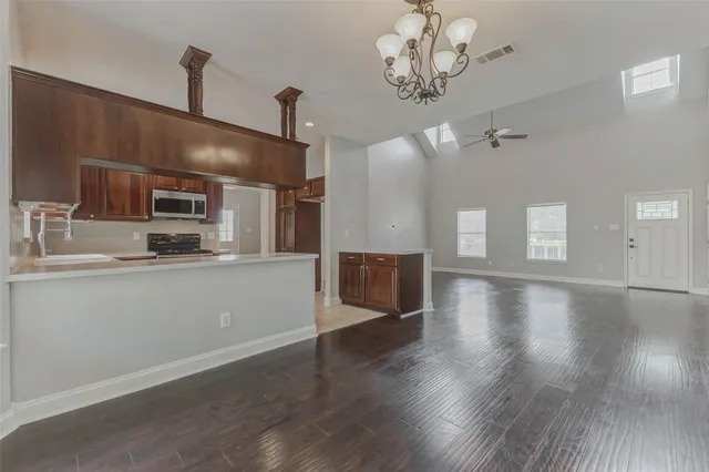 a kitchen with stainless steel appliances granite countertop a sink and cabinets