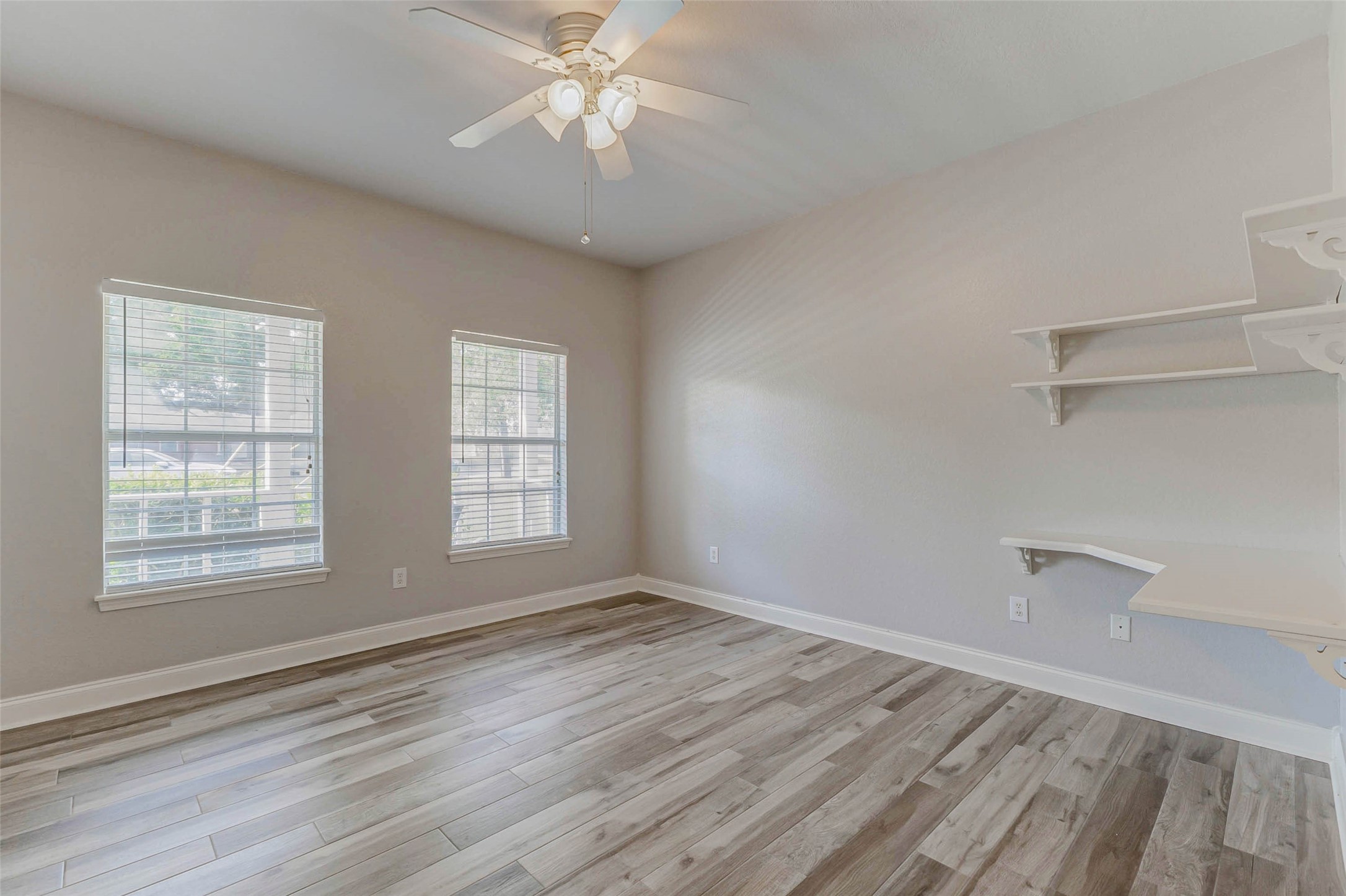 8411 Syms Street Fulshear, TX 77441 - Photo 18 of 29 a view of an empty room with a window and wooden floor