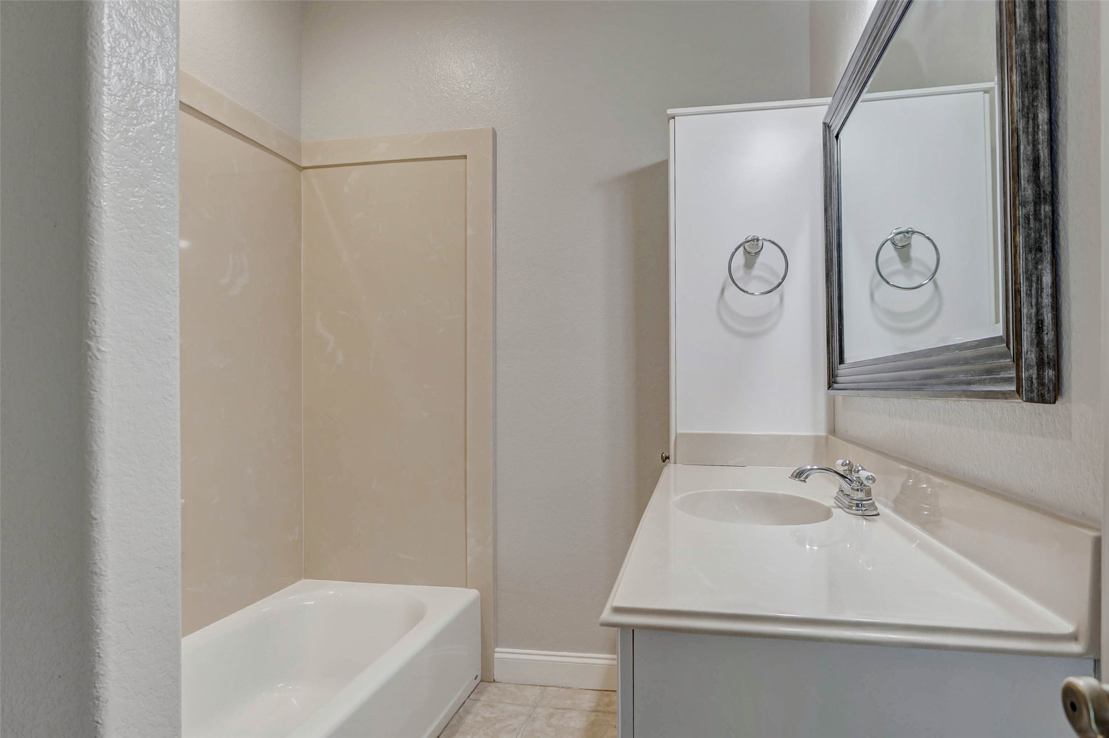 8411 Syms Street Fulshear, TX 77441 - Photo 20 of 29 a bathroom with a sink and a tub