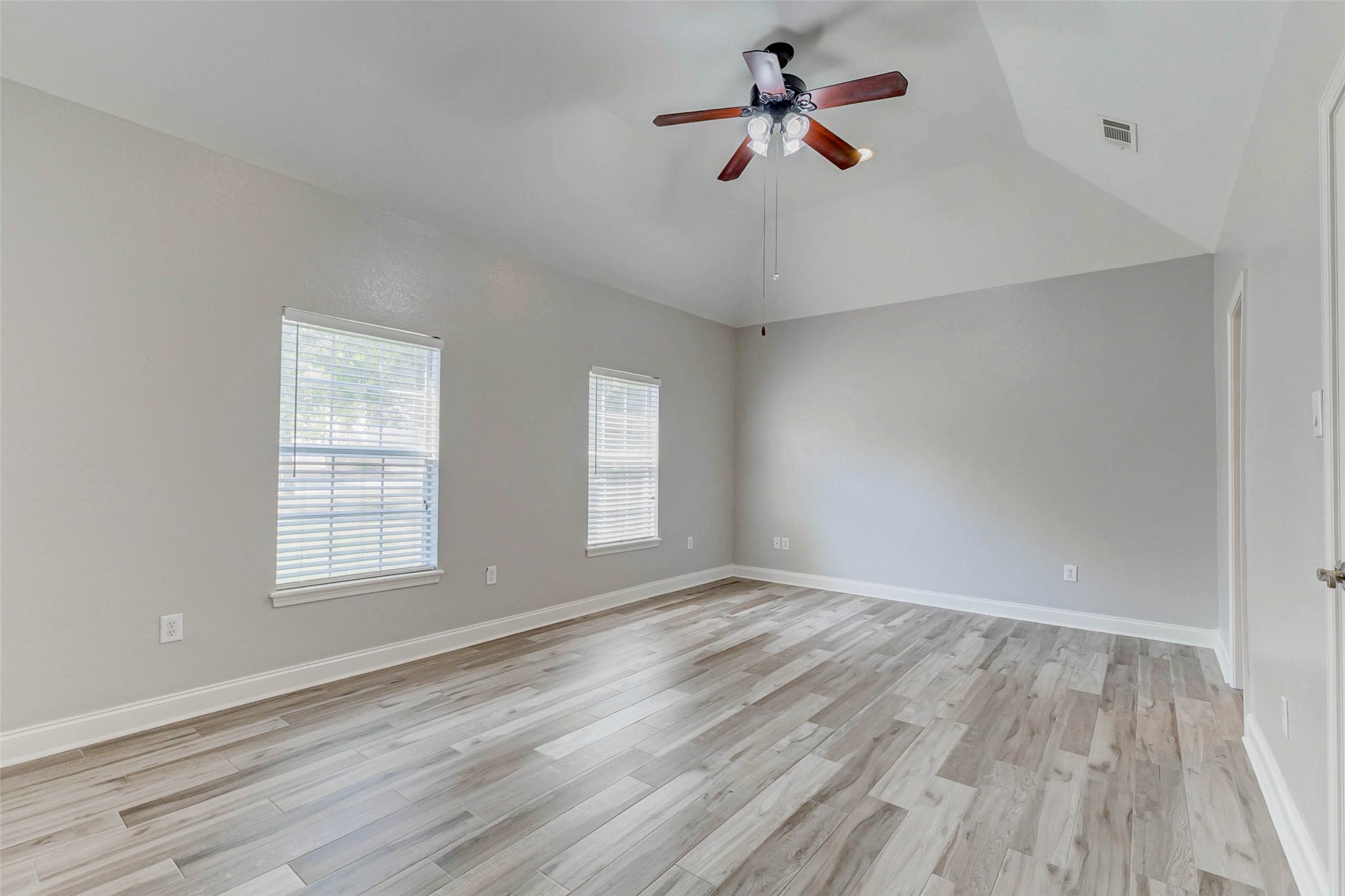 8411 Syms Street Fulshear, TX 77441 - Photo 22 of 29 wooden floor in an empty room with a window