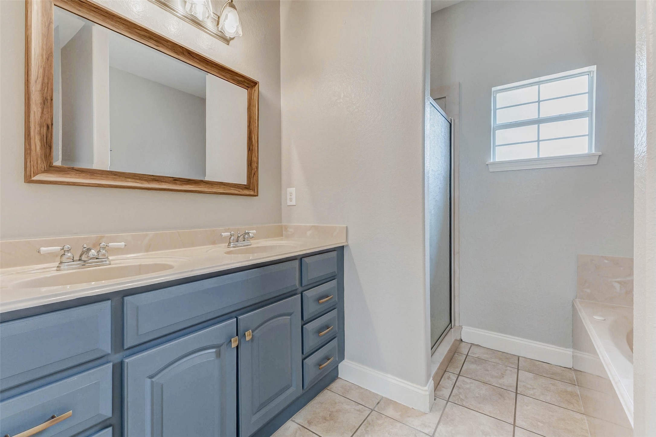 8411 Syms Street Fulshear, TX 77441 - Photo 25 of 29 a bathroom with a sink and a mirror