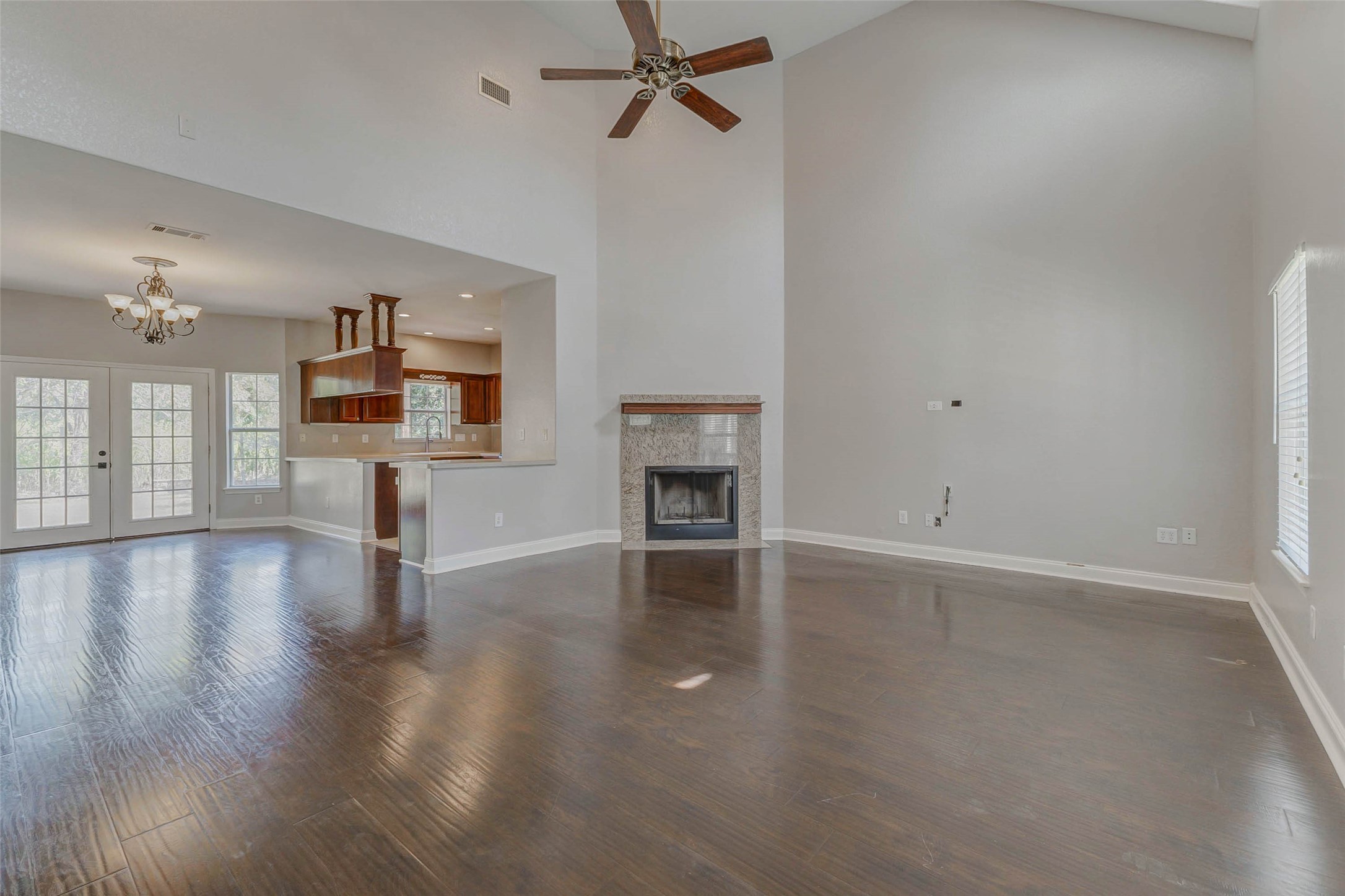 8411 Syms Street Fulshear, TX 77441 - Photo 29 of 29 wooden floor in an empty room with a fireplace