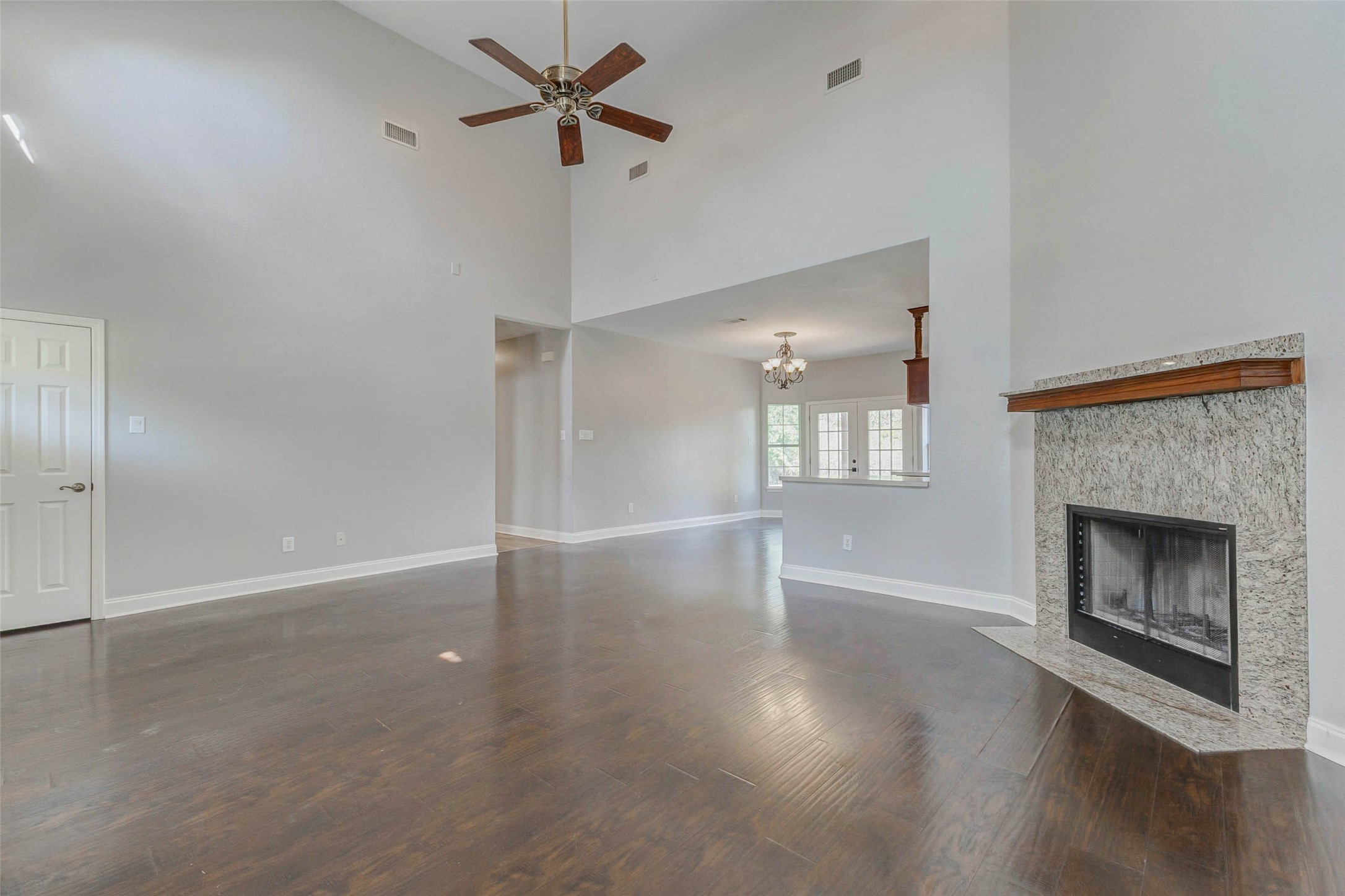 8411 Syms Street Fulshear, TX 77441 - Photo 8 of 29 a view of empty room with wooden floor and fireplace