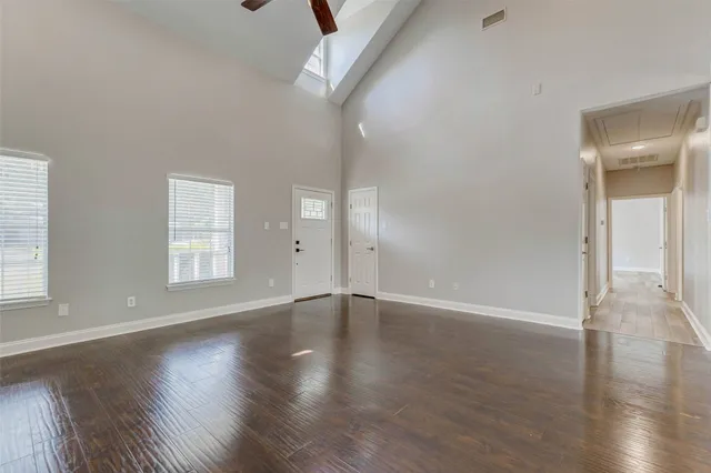 a view of empty room with wooden floor and fireplace