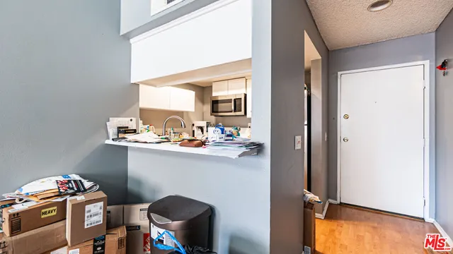 a view of a kitchen with a sink and cabinets