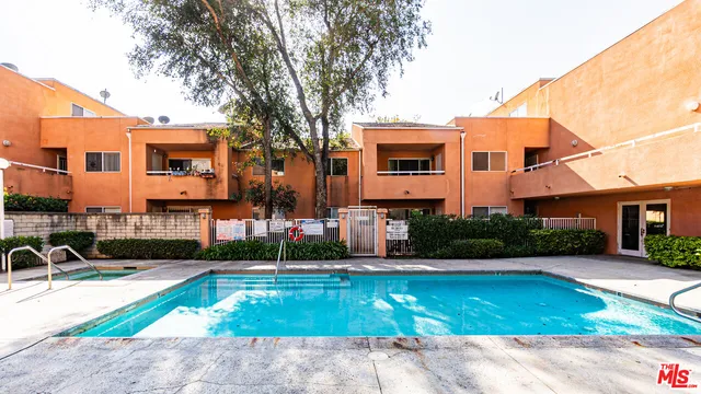 a view of a building with a yard and sitting area