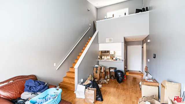 a view of a living room with furniture and wooden floor