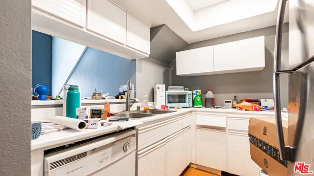 a kitchen with a sink cabinets and appliances