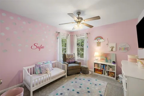 a bedroom with furniture and a chandelier