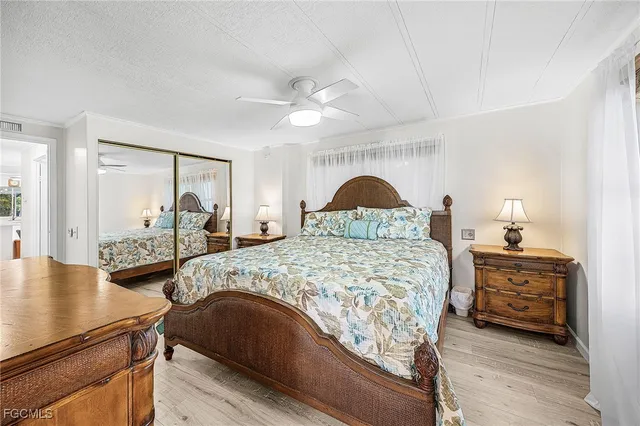 a bedroom with bed and wooden floor