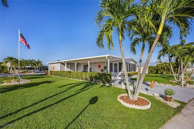 a front view of a house with a yard table and chairs