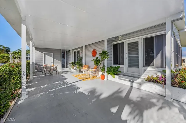 a view of a house with backyard and sitting area