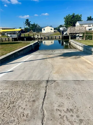 a row of palm trees and a yard with swimming pool