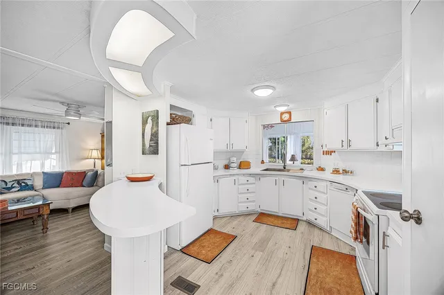 a kitchen with a sink a stove and cabinets