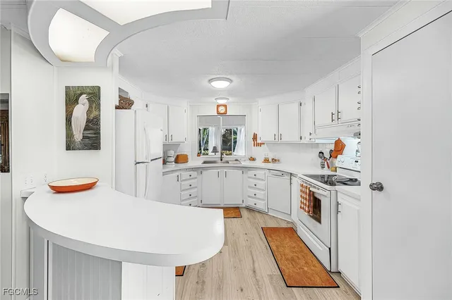 a kitchen with stainless steel appliances granite countertop a sink and cabinets