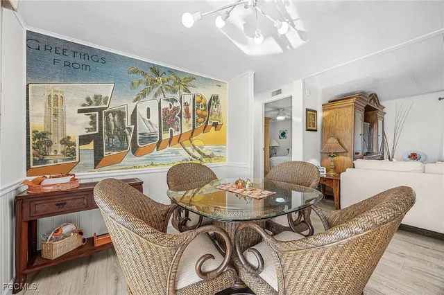 a living room with furniture a dining table and a chandelier