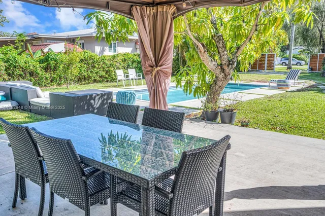 a view of an outdoor space with dining table and chair