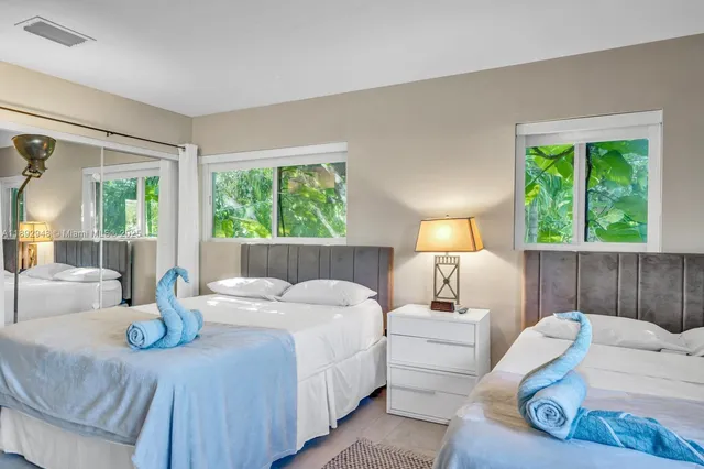 a bedroom with a bed and a large window