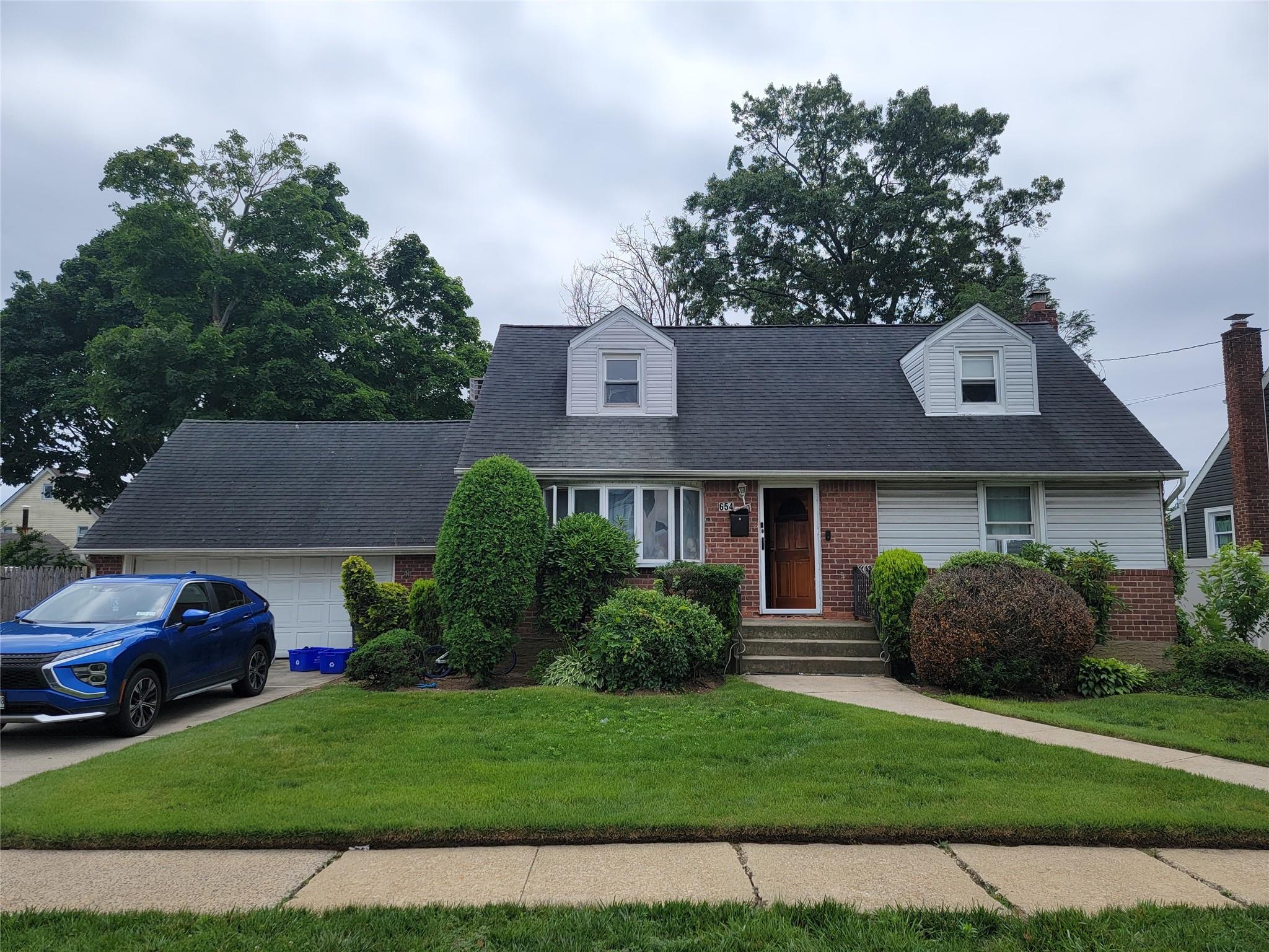 a front view of a house with a garden