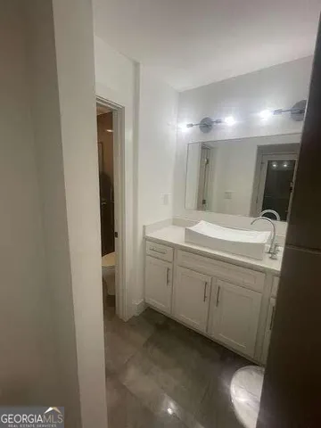 a bathroom with a double vanity sink and a mirror