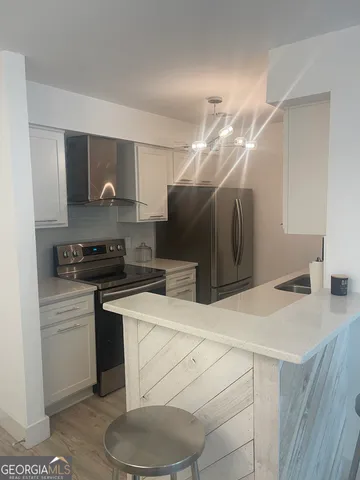 a kitchen with a sink a stove and refrigerator