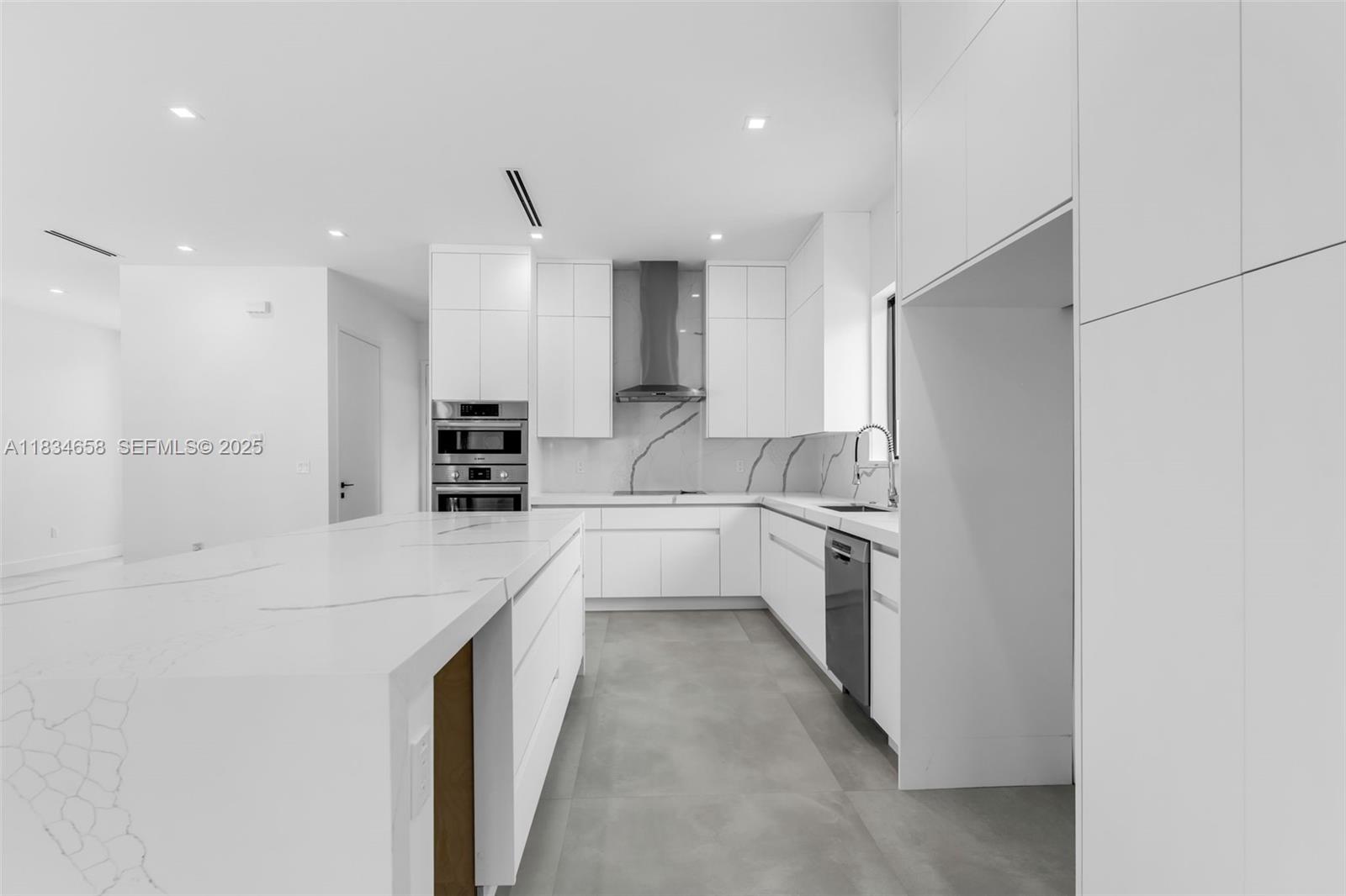 8220 Southwest 193rd Terrace Cutler Bay, FL 33157 - Photo 13 of 59 a large kitchen with a large counter top appliances and cabinets