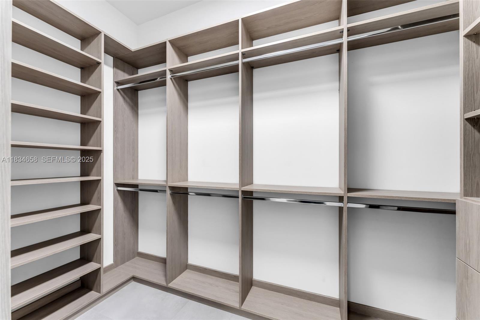 8220 Southwest 193rd Terrace Cutler Bay, FL 33157 - Photo 23 of 59 a view of walk in closet with empty racks