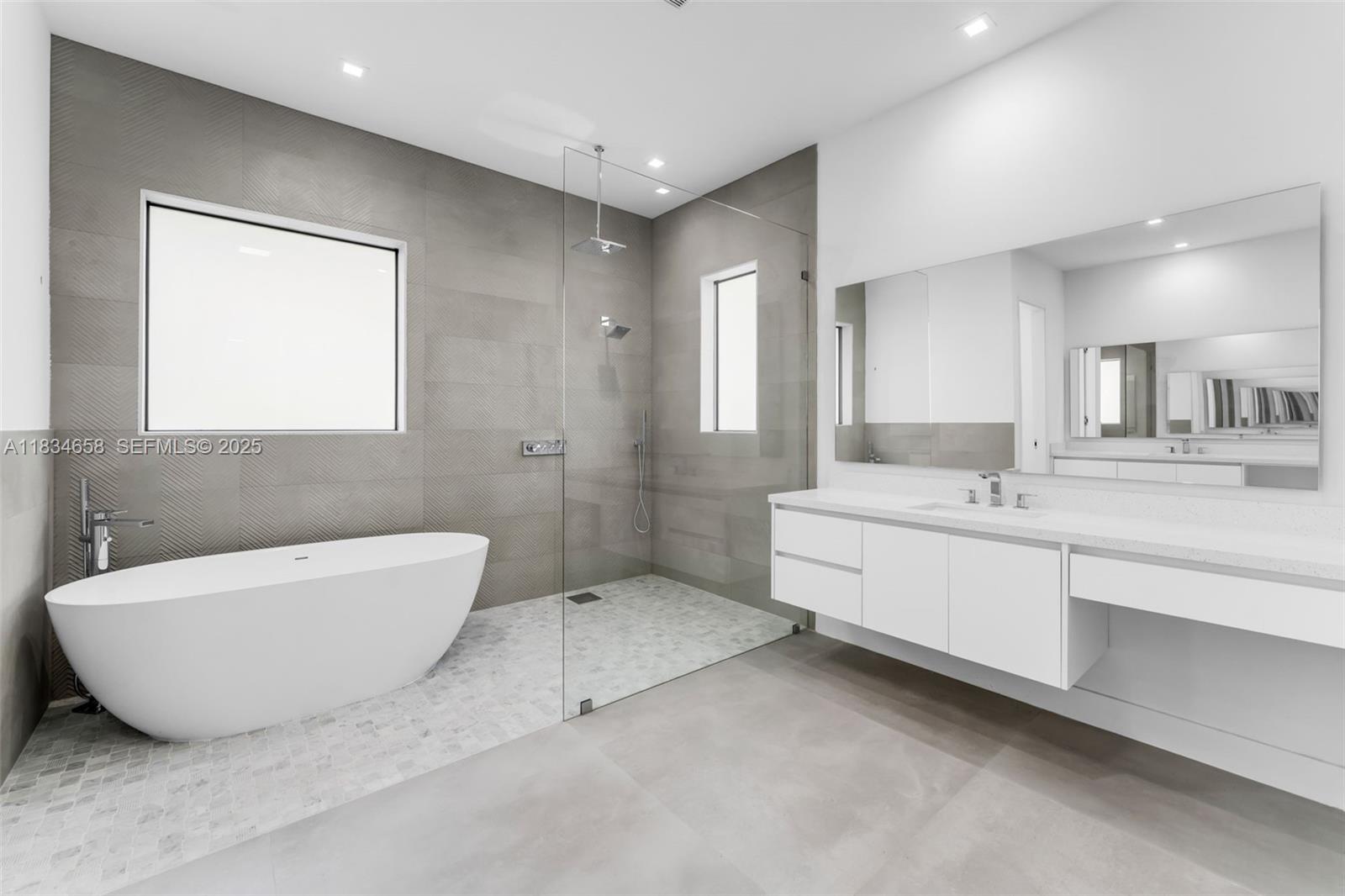 8220 Southwest 193rd Terrace Cutler Bay, FL 33157 - Photo 24 of 59 a bathroom with a double vanity sink mirror and bathtub