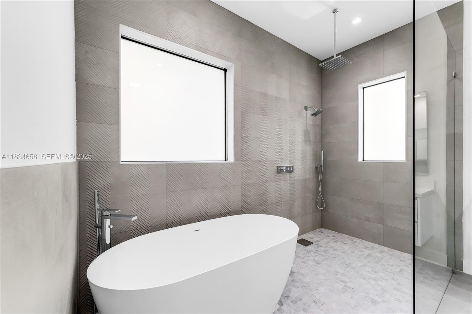 8220 Southwest 193rd Terrace Cutler Bay, FL 33157 - Photo 26 of 59 a white bath tub sitting next to a window