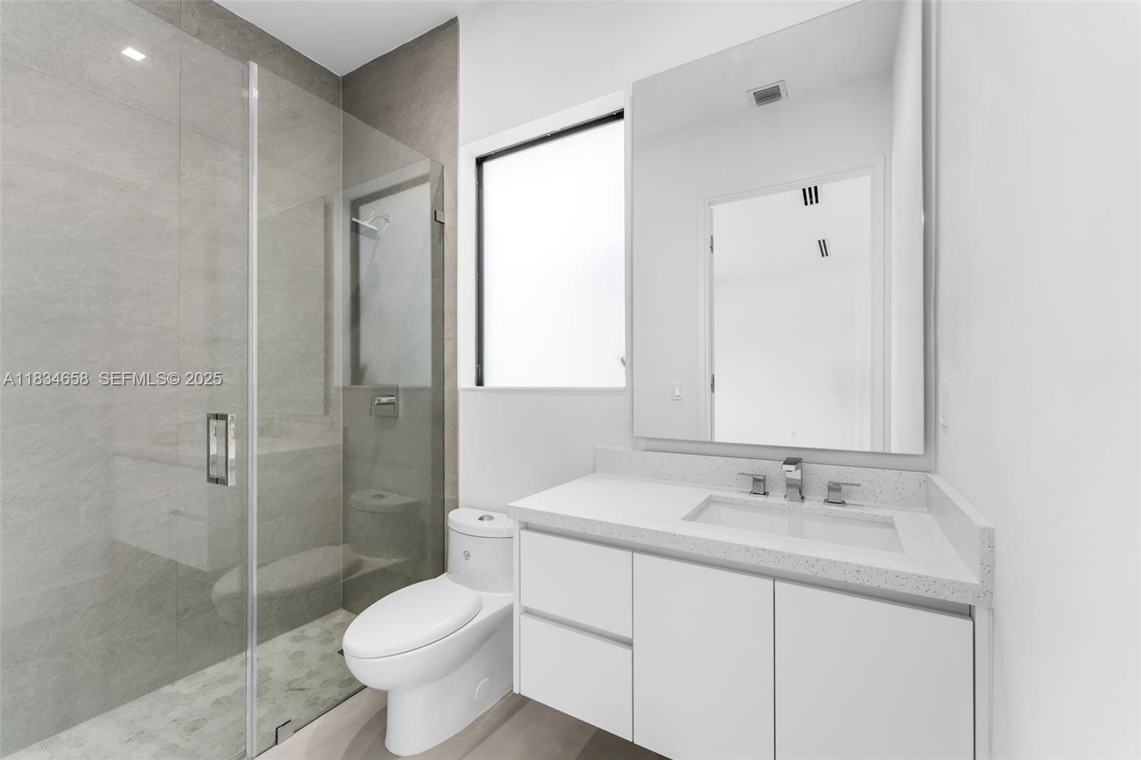 8220 Southwest 193rd Terrace Cutler Bay, FL 33157 - Photo 32 of 59 a bathroom with a sink toilet and shower