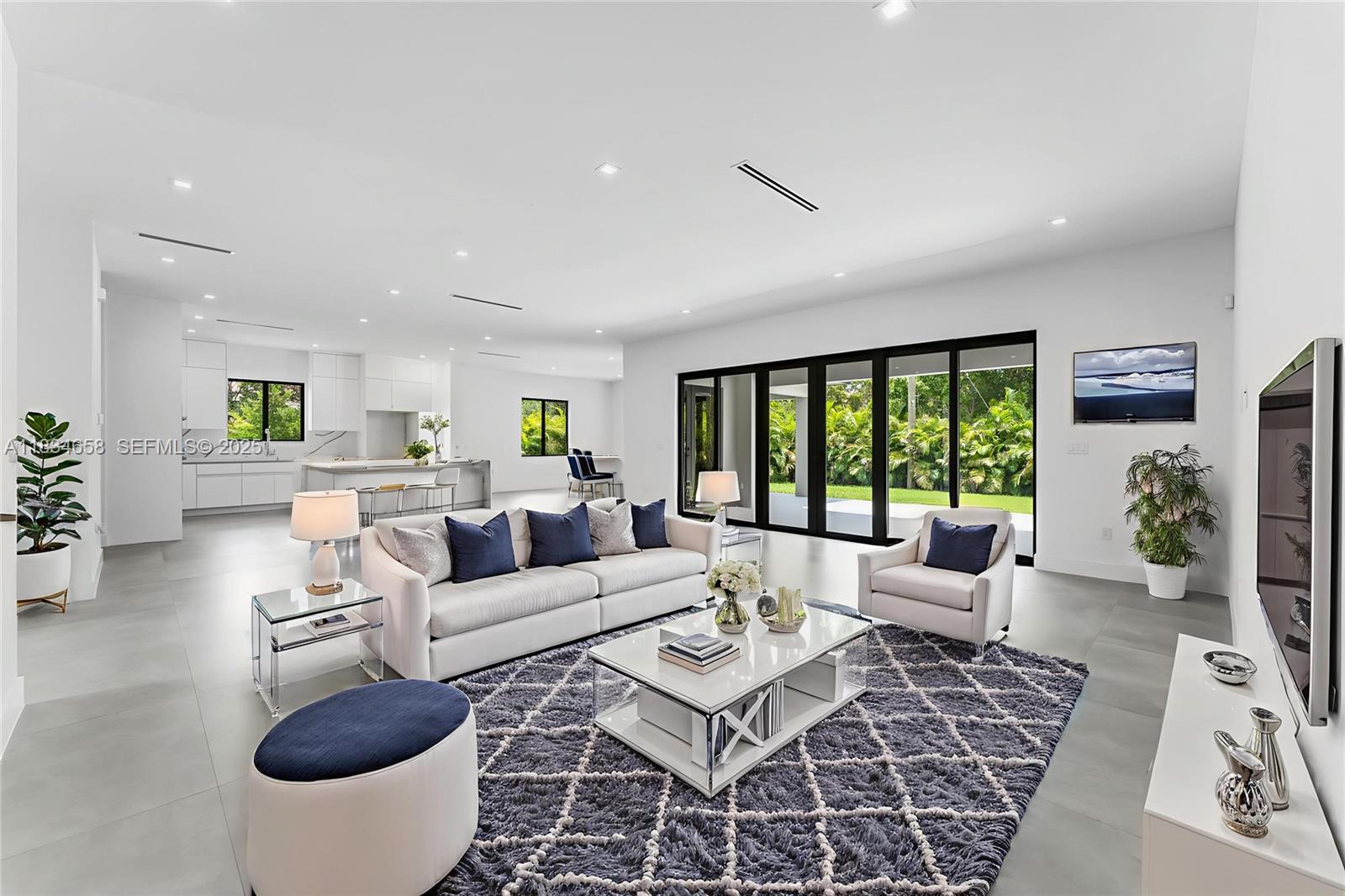8220 Southwest 193rd Terrace Cutler Bay, FL 33157 - Photo 5 of 59 a living room with furniture a rug and a large window
