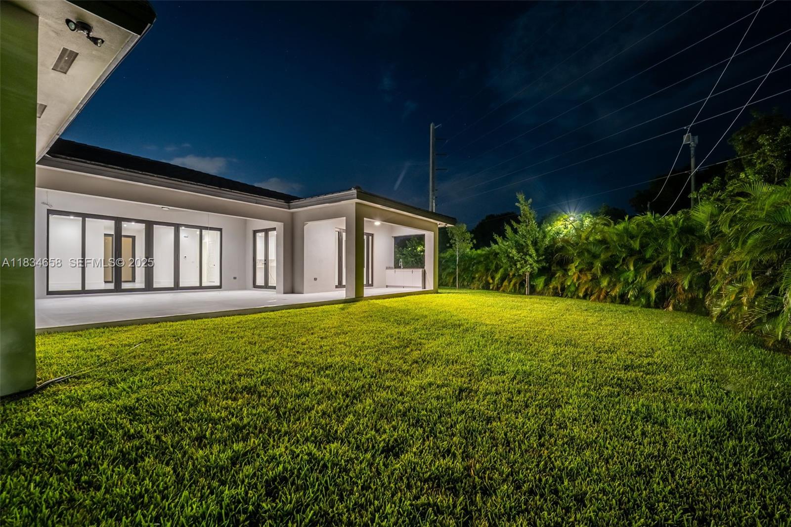 8220 Southwest 193rd Terrace Cutler Bay, FL 33157 - Photo 54 of 59 a view of a house with backyard and garden