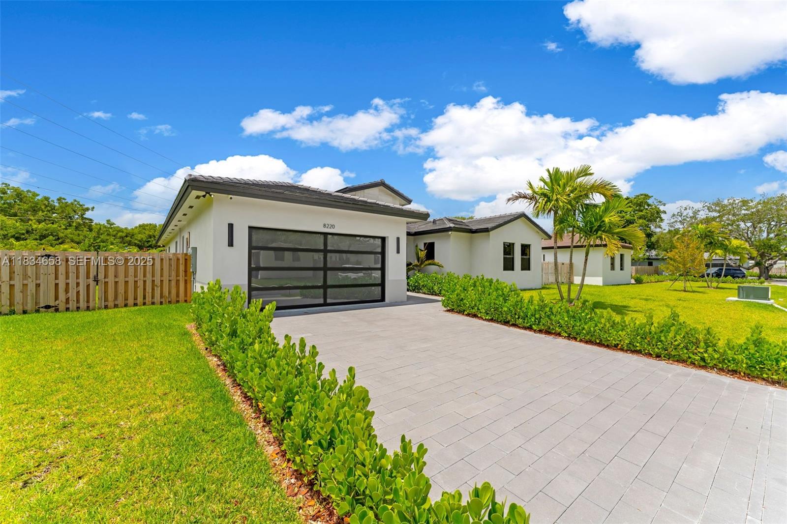 8220 Southwest 193rd Terrace Cutler Bay, FL 33157 - Photo 57 of 59 a front view of a house with garden